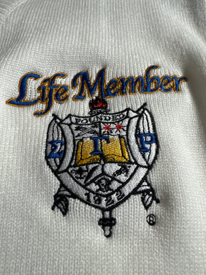 Embroidered logo on a white fabric with 'Life Member' text
