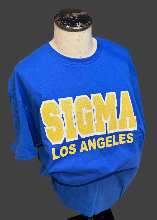 Blue shirt with 'Sigma Los Angeles' text on a mannequin against a neutral background
